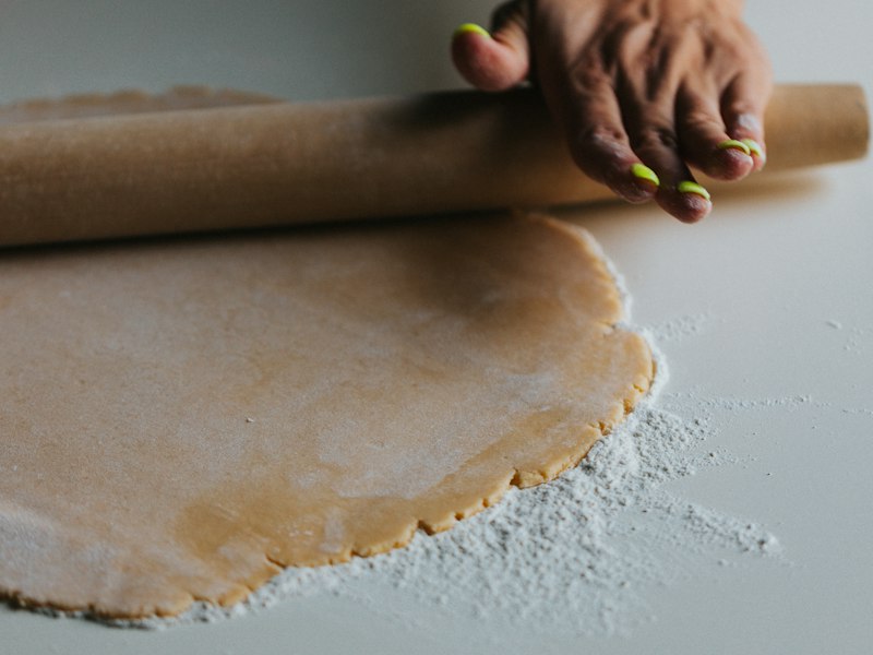 Rolling out pie pastry on a floured counter